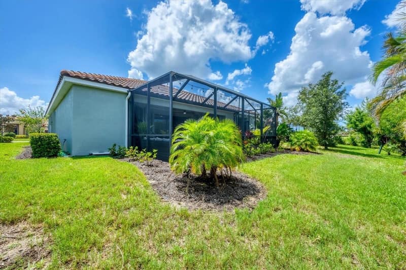 The glass-enclosed lanai from the garden