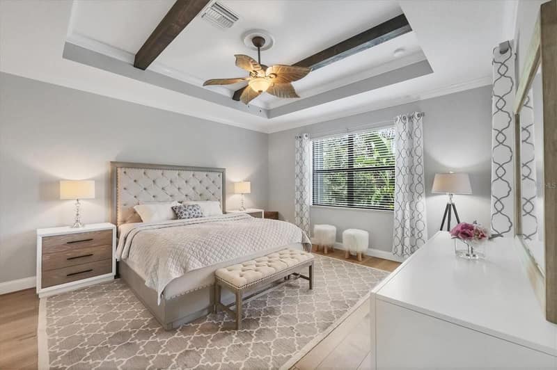 Bedroom with blinds and a ceiling fan
