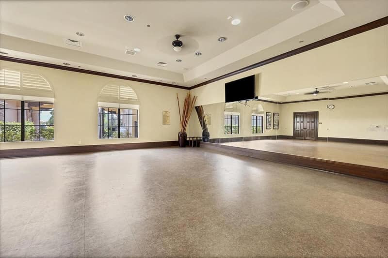 Bonus room with a mirrored wall and TV