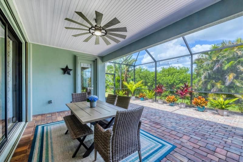 Lanai dining table surrounded by planting