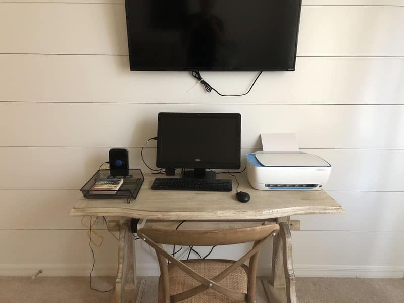 Desk set up for working, with monitor and printer